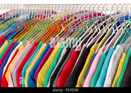 Colored shirts on hangers steel closeup. Stock Photo