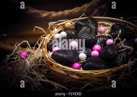 chocolates in metal basket with lady purse Stock Photo