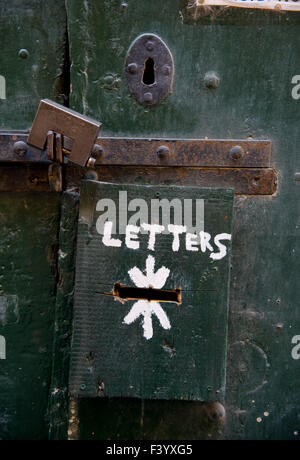 Temporary letterbox on ancient padlocked door Valletta Malta Stock Photo