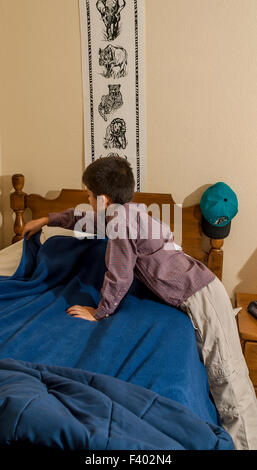 multi ethnic inter racial diversity racially diverse multicultural multi cultural interracial boy 7-10 year old olds making bed. MR ©Myrleen Pearson Stock Photo