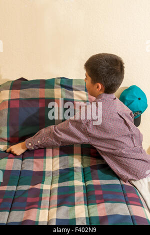 California child children making bed helping responsible  racially diverse multicultural  multi cultural interracialKorean/American boy.   MR ©Myrleen Pearson Stock Photo