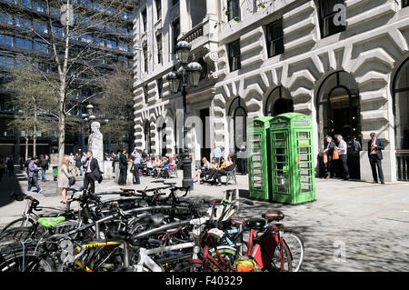 Office workers on lunch break outside The Royal Exchange Buildings, City of London, England, UK Stock Photo