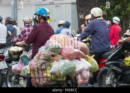 There are over 45 million scooters motorbikes in Vietnam.Typical scene from Ho Chi Minh ( Saigon) city centre with commuters. Stock Photo