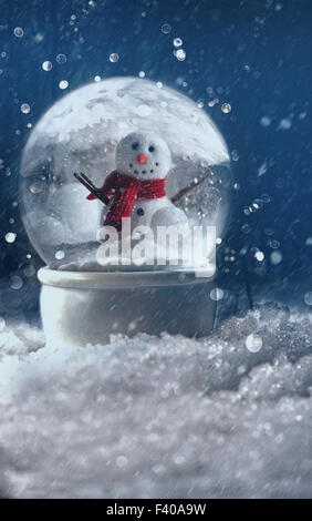 Snow globe in a snowy winter background Stock Photo