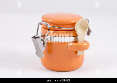 Ceramic orange salt shaker with a lid Stock Photo