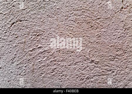 closeup of a rustic beige plastered wall to be used as a texture or a background Stock Photo