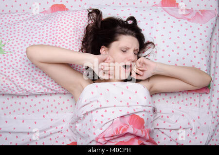 Girl waking yawns and stretches Stock Photo