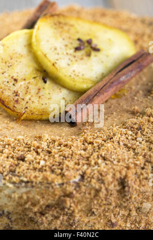 Cinnamon sticks and apples on the cake. Stock Photo