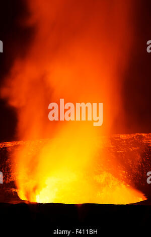 Tree in silhouette at dusk, lava glowing, Kilaueea Caldera volcano, Hawai'i Volcanoes National Park, Big Island, Hawaii, USA Stock Photo