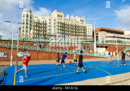 A group of men playing basketball at Brighton and Hove seafront, East Sussex, England. Stock Photo