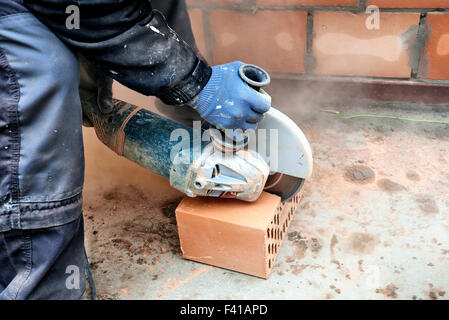Construction worker using masonry saw to cut concrete blocks to build a new wall Stock Photo