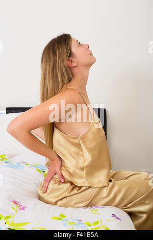 young woman feeling the pain in her back Stock Photo