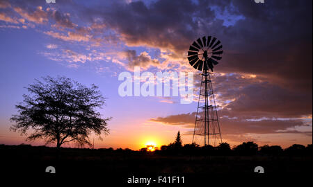 Windmill in desert sunset Stock Photo