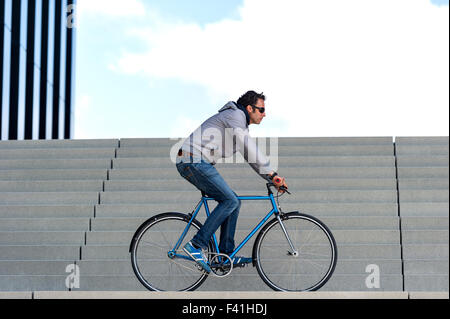 A Man with his Bike in a big city (MR) Stock Photo