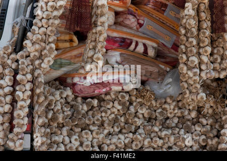 Bunch of dried garlic clove plaits for sale on a gypsy peddler's van. Stock Photo