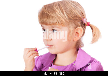 Small girl with lipstick isolated on white Stock Photo