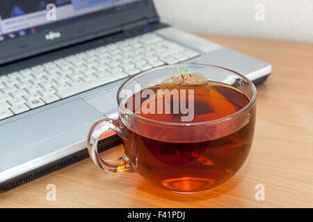 A cup of tea on a table, notebook Stock Photo