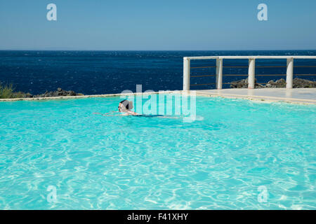 Woman swimming in a swimming pool, Kalypso Cretan Village Hotel, Karavos, Plakias,  Rethymno regional unit, Crete, Greece Stock Photo