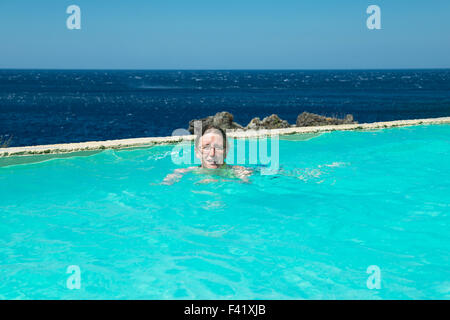 Woman swimming in a swimming pool, Kalypso Cretan Village Hotel, Karavos, Plakias,  Rethymno regional unit, Crete, Greece Stock Photo