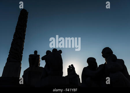 Silhouette, granite sculptures in front of monolith of people by Gustav Vigeland, Vigeland Sculpture Park, Frognerparken Stock Photo