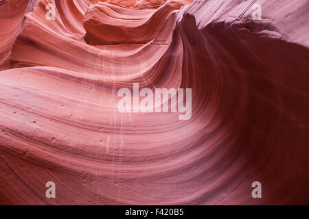 A swirling, carved sandstone canyon with dried moisture drippings of sand running down the wall in Canyon X. Stock Photo