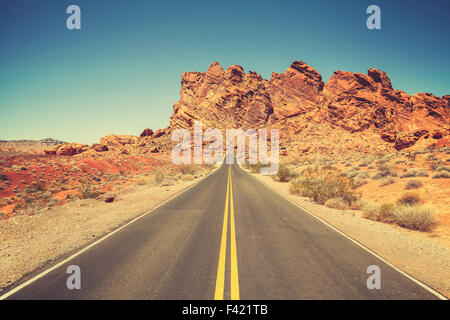 Retro stylized road through rocky desert in Valley of Fire State Park, Nevada. Stock Photo