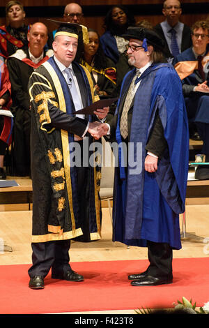 London, UK. 13th Oct, 2015. Malcolm Garrett receiving Honorary Doctorate from London South Bank University at Royal Festival Hall, London, !3th October 2015. Malcolm Garett is a Graphic Designer who designed numerous album covers in the 70s and 80s and went on to become creative director at AIG and later at IMAGES&CO.  In 2003 he was named by Design Week as one of the 'Hot 50 people making a difference in design'. Credit:  Peter Reed/Alamy Live News Stock Photo