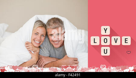 Composite image of cute valentines couple Stock Photo