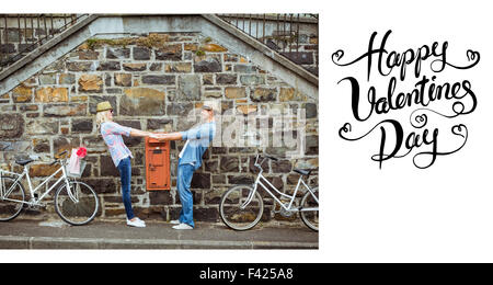 Composite image of cute valentines couple Stock Photo