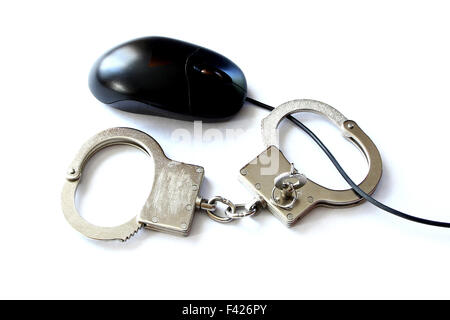 computer hacker equipment and hand cuffs locked up on white table Stock Photo