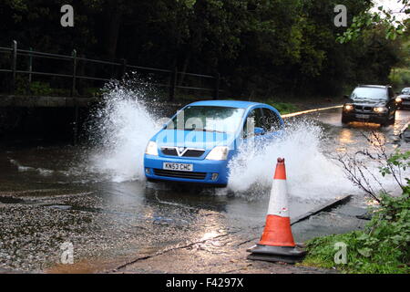 A car drives through the ford on the A614 by Rufford Mill near Rufford Abbey Country Park, Nottinghamshire, England UK Stock Photo