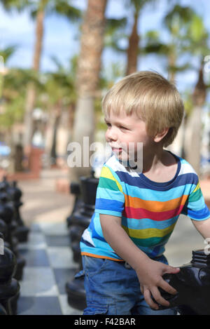 Child playing with giant chess Stock Photo