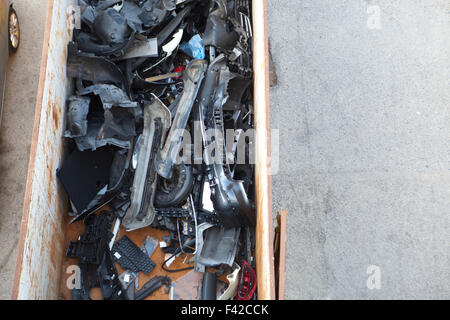 Container full of pieces of cars at car workshop Stock Photo