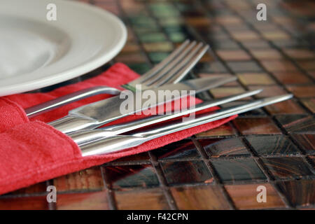 Fork, knives and a plate Stock Photo