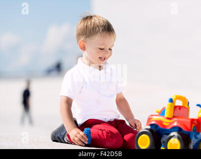 Little boy playing with toy car horizontal Stock Photo