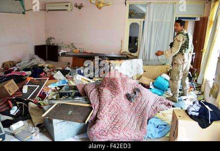 Kunduz, Afghanistan. 14th Oct, 2015. A policeman stands in a destroyed room of a civilian house after Taliban fighters broke it down in Kunduz city, capital of northern Kunduz province, Afghanistan, Oct. 14, 2015. The Afghan security forces evicted Taliban militants from the northern Kunduz city on Oct. 13 and begun returning normalcy there after 11 days of fierce fighting and cleanup operations, provincial police chief Mohammad Qasim Jangal Bagh said. Credit:  Omid/Xinhua/Alamy Live News Stock Photo
