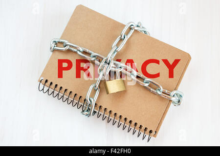 Privacy protection concept, notepad with chain and padlock Stock Photo
