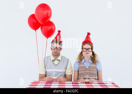 Geeky hipster couple celebrating his birthday Stock Photo