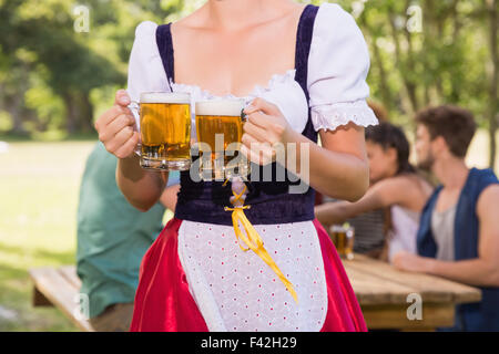 Pretty oktoberfest girl holding beer tankards Stock Photo