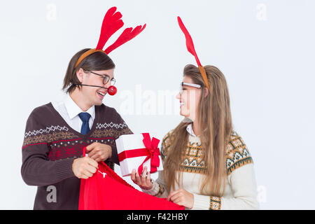 Happy geeky hipster couple holding present Stock Photo