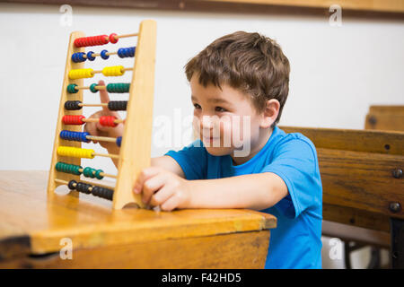Student doing maths on abacus Stock Photo