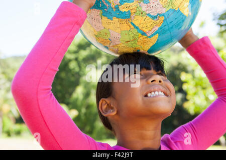 Cute little girl holding globe Stock Photo