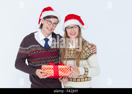 Geeky hipster couple holding present Stock Photo