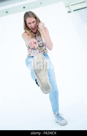 Woman doing karate kick Stock Photo