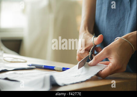 Woman cutting fabric, cropped Stock Photo