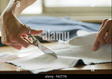Woman cutting fabric, cropped Stock Photo