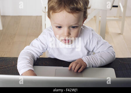 Little boy using laptop computer Stock Photo