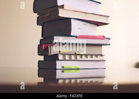 Textbooks stacked on table Stock Photo