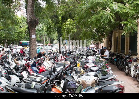 row after row of parked motorcycle scooters in Hanoi the capital of Vietnam. over 45 million scooters in Vietnam,Asia Stock Photo