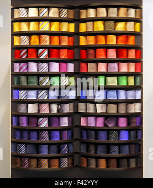 Big collection of colourful ties in rack Stock Photo